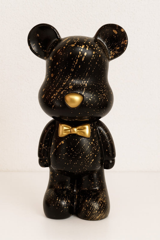 Stijlvol berenbeeld in zwart met gouden spetters (12 x 28 cm). Decoratief beeld met spaarpotfunctie – perfect als woonaccessoire of uniek cadeau.
